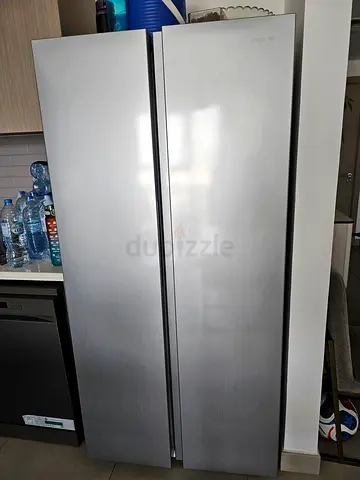 Large silver side-by-side refrigerator in good condition. Useing only few monts