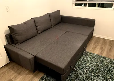 Dark grey fabric L-shaped sofa bed good condition