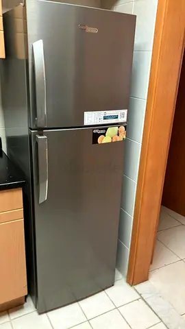 Silver top-freezer refrigerator in good working condition