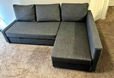 L-shaped grey sofa bed with storage