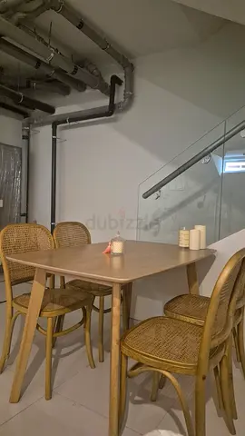 Rattan-style wooden dining table with 4 matching chairs