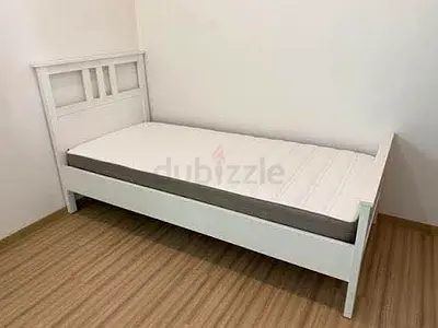 Single white wooden bed frame with mattress