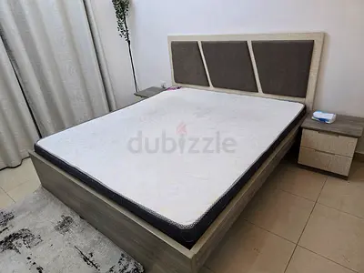 King size bed frame with mattress and two bedside tables