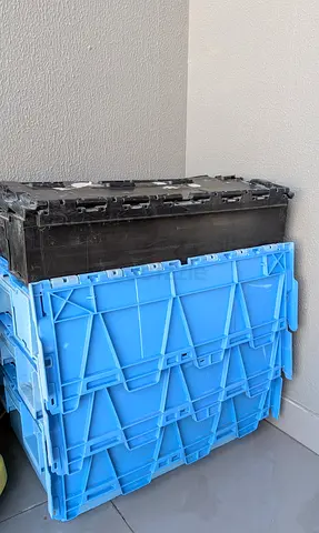 Heavy-duty foldable plastic storage crates with lids.