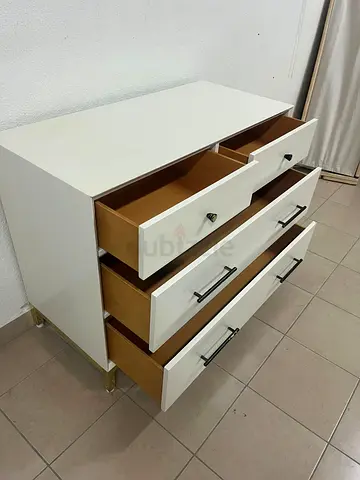 White drawer unit with black and gold handles from Home Centre