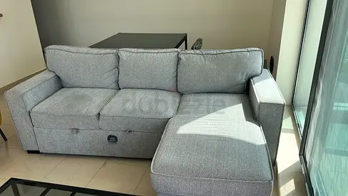 Light grey fabric L-shaped sofa with storage, good condition