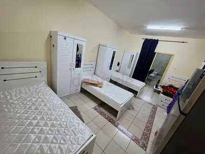 Bed space with a balcony with a fridge