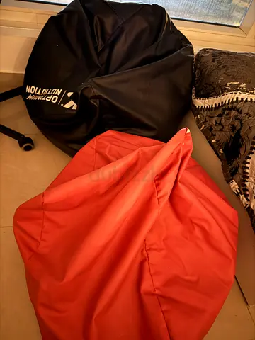Two comfy bean bag chairs — black and coral, good condition