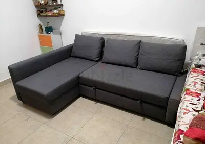 L-shaped grey fabric sofa bed with storage chaise and storage