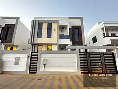 Spacious villa for rent in Al Helio 1, Ajman. Features 5 master bedrooms, a majlis, large hall, and