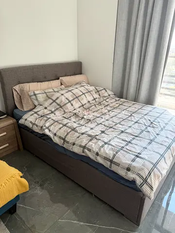 Used fabric upholstered double bed with mattress