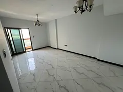 For annual rent in Al-Jarf 2: One bedroom and living room, two bathrooms, balcony, central air cond