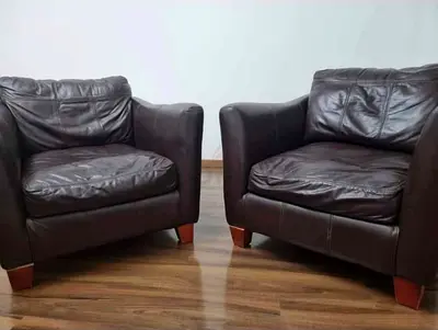 Pair of dark brown leather armchairs - comfortable lounge chairs