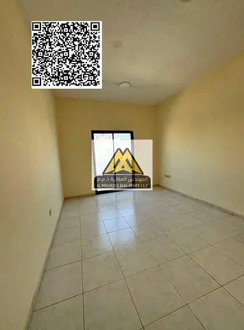 A 1-bedroom apartment with a living room for annual rent in Al Nuaimiya 2 – Ajman, featuring a spac