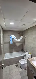 Master room with attached bathroom with window and built in cabinet