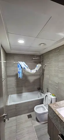 Master room with attached bathroom with window and built in cabinet