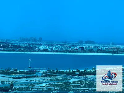 Largest two-bedroom apartment with a living room, near Dubai exit, central gas, central air conditioning, gym, swimming pool, and parking.