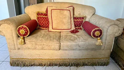 Two-seater upholstered sofa with cushions (used)