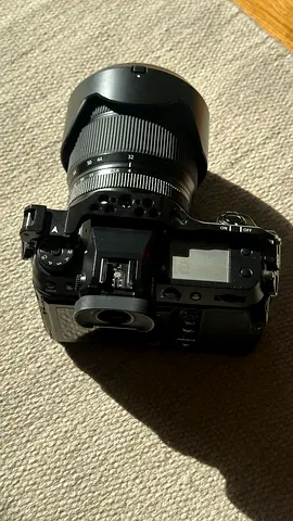 Fujifilm mirrorless camera body (no lens) with protective cage