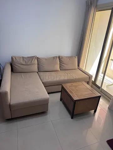 Beige L-shaped Sofa cum bed. with Ottoman - Good Condition