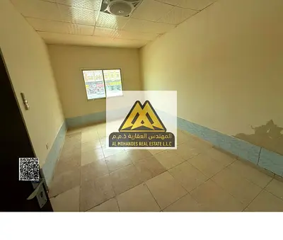Studio Al Mowaihat 3 Ajman. Separate kitchen, split AC. Near Dubai & Sharjah exits. AED 18,000 yearly, 4 payments, prime location.