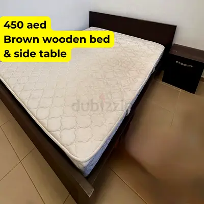 Brown wooden double bed with mattress and matching bedside table - AED 450