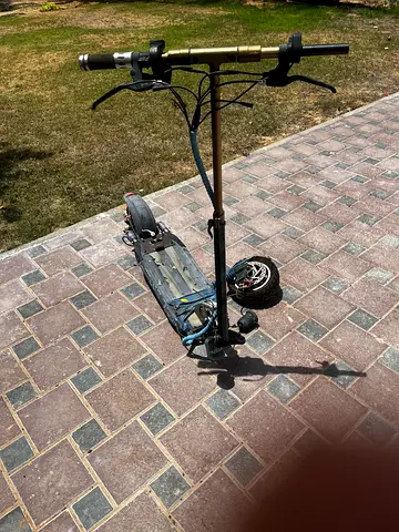 Used electric scooter with large deck and suspension — needs minor repairs