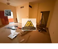 Two-bedroom apartment with hall in Al Nuaimiya 2, central AC. 32,000 yearly, 4 payments. Maintenance