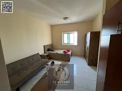 Spacious studio apartment for annual rent, unfurnished, in Al Rashidiya 3, with a separate kitchen.