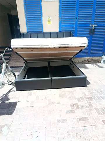 King-size storage bed frame with hydraulic lift and mattress
