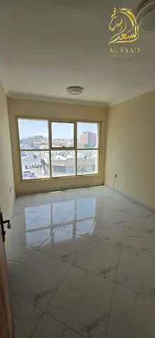 One-bedroom apartment with a living room and two bathrooms in Al Rawda 2