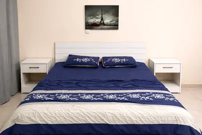 King size bed with side table and mattress.