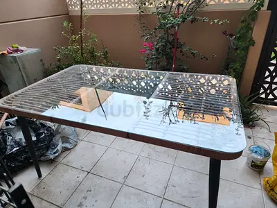 Used Rectangular Outdoor Glass-Top Dining Table with Metal Legs and 4 chairs with cushions