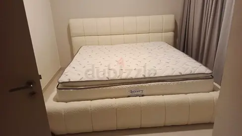 Queen upholstered bed frame with mattress - cream, good condition
