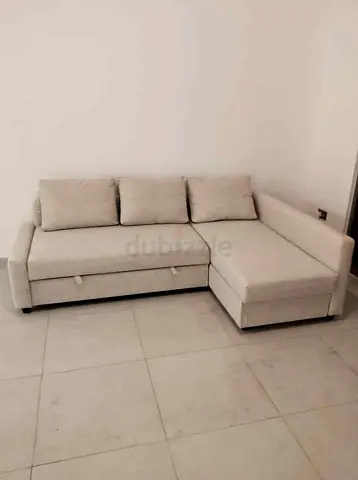Light beige L-shaped sectional sofa with storage, good condition