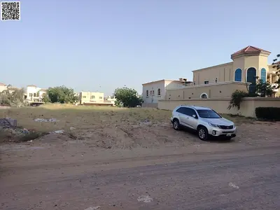 Two residential plots of land for sale, each 20,000 square feet, in a prime location in Al Muwaihat 2 area, Ajman.