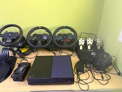 Xbox One console (No Controller) with multiple racing wheels and pedals — bundle