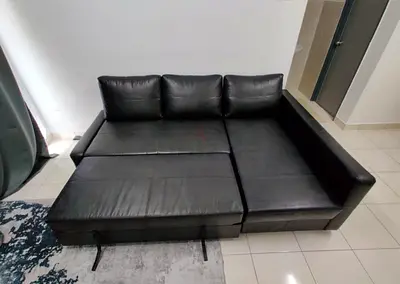 Black L-shaped leather sofa bed - convertible sectional, good condition