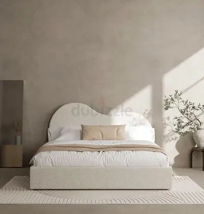 Queen upholstered bed with curved headboard in cream