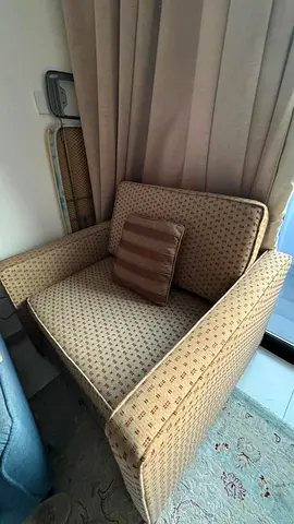 Single upholstered armchair with cushion - neutral patterned fabric