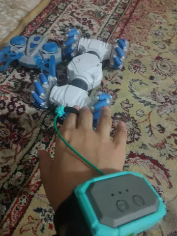 Remote-controlled stunt car with wrist controller - used