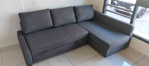 L-shaped grey fabric sofa bed with chaise - good condition