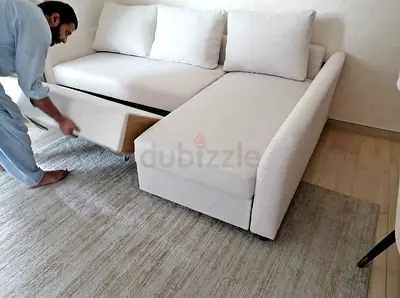 L-shaped white fabric sofa bed with storage chaise