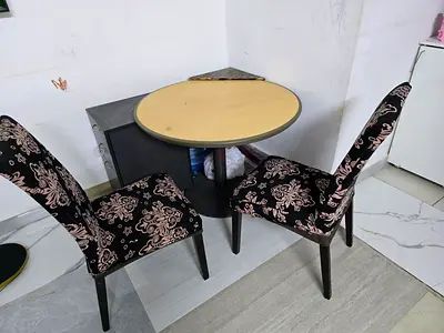 Small round dining table with two patterned chairs