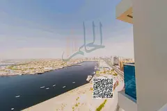 Two-bedroom apartment for sale in Ajman's new Oasis Tower with swimming pool, gym, and parking.