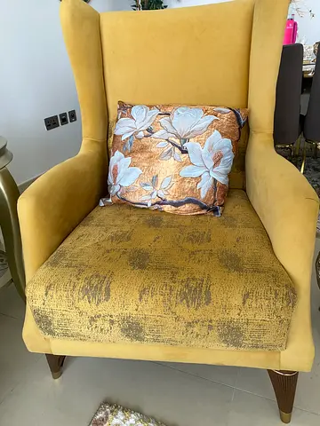 Yellow upholstered accent armchair with floral cushion - used