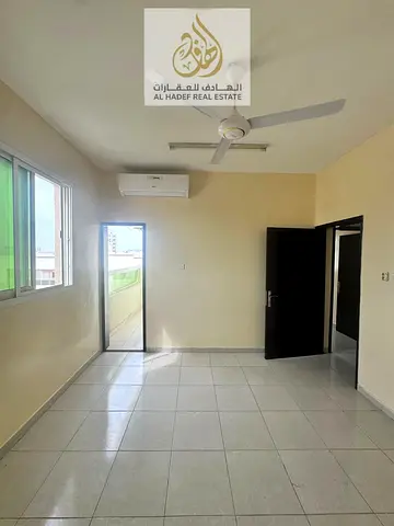 Two bedrooms, a large living room with a balcony, and two bathrooms in Al Rawda 1, Ajman.