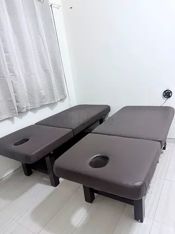 Pair of brown massage/therapy tables with face holes