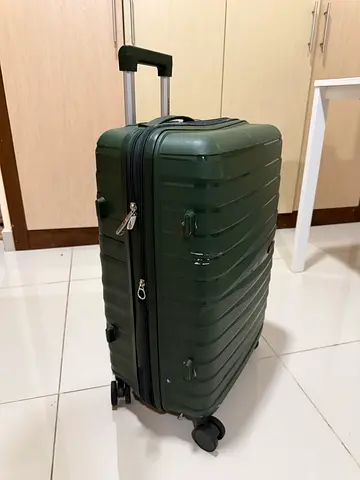 Dark green hard-shell carry-on spinner suitcase with telescopic handle