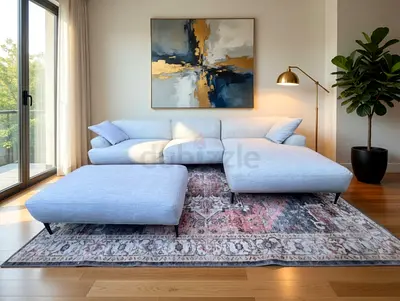 The Loom collection L shape sofa beige Light Blue L-Shaped Sofa with Ottoman on Patterned Area Rug